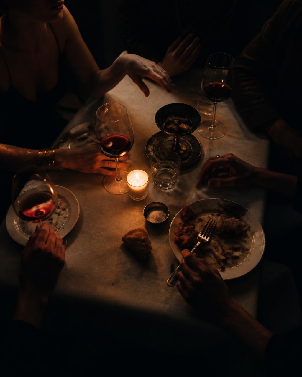 A candlelit dinner table late in the evening
